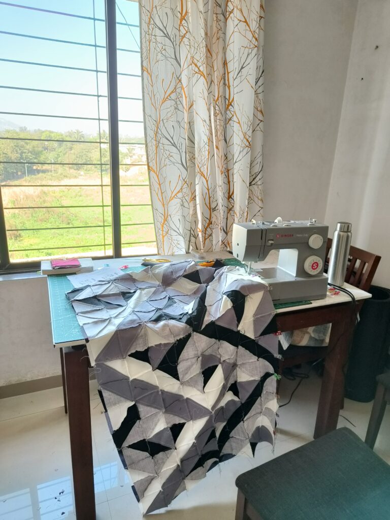 Beginner quilting setup on a wooden table with colorful fabric pieces, thread, and sewing tools.