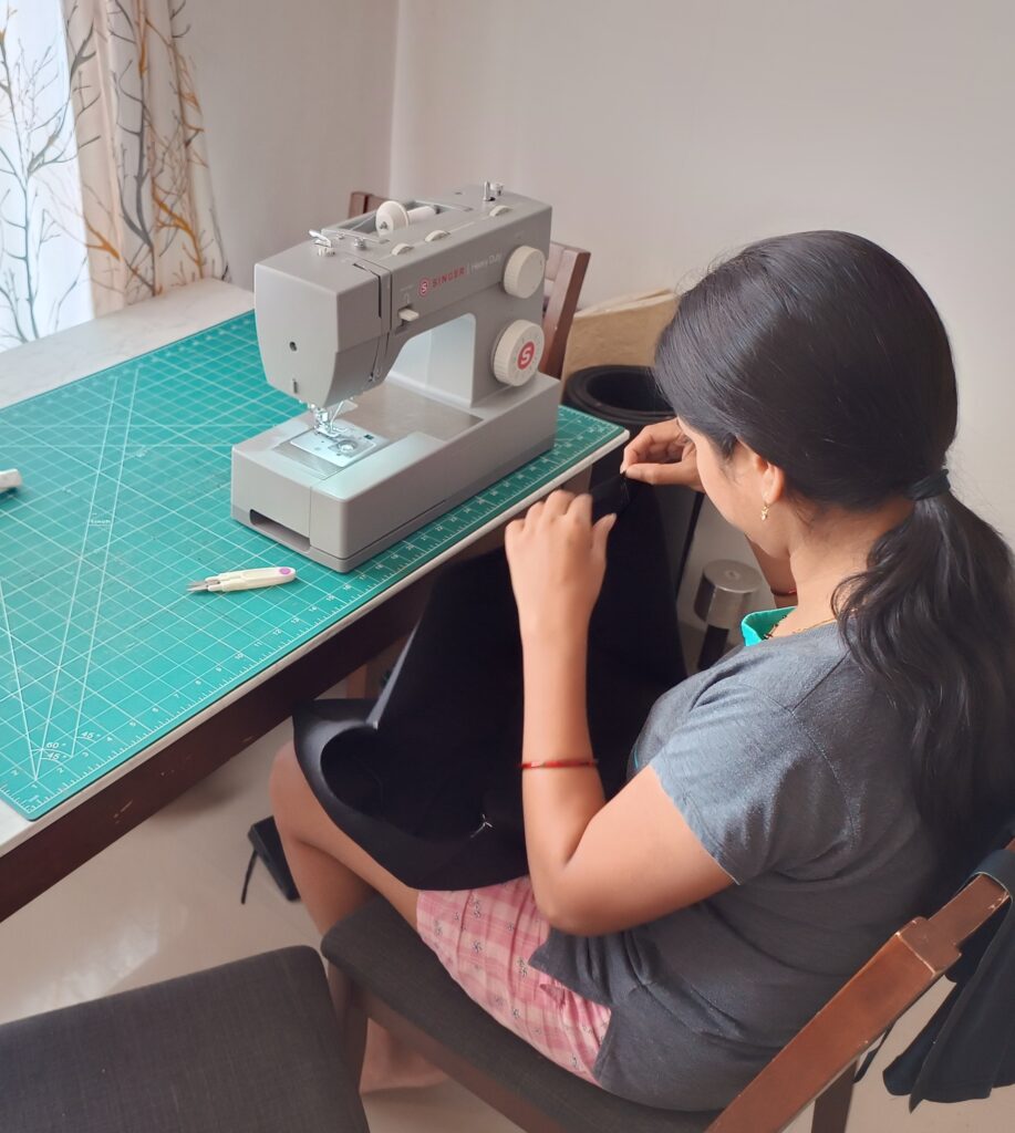 Cozy home sewing corner with natural light, quilt blocks in progress, and a new sewing machine.